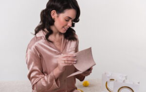 Tânără în pijamale de satin, accesorizata cu bijuterii din aur